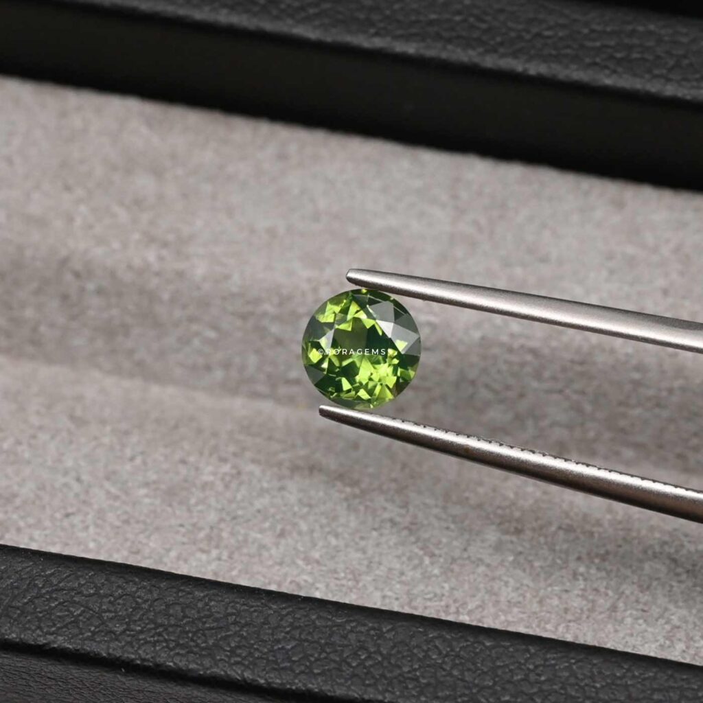 Round cut green zircon gemstone suitable for rings, pendants, earrings, and custom jewelry designs.