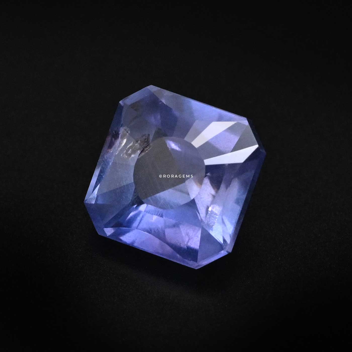 Modern fancy cut Sri Lankan sapphire gem with natural color variations and brilliance with artistic inclusions